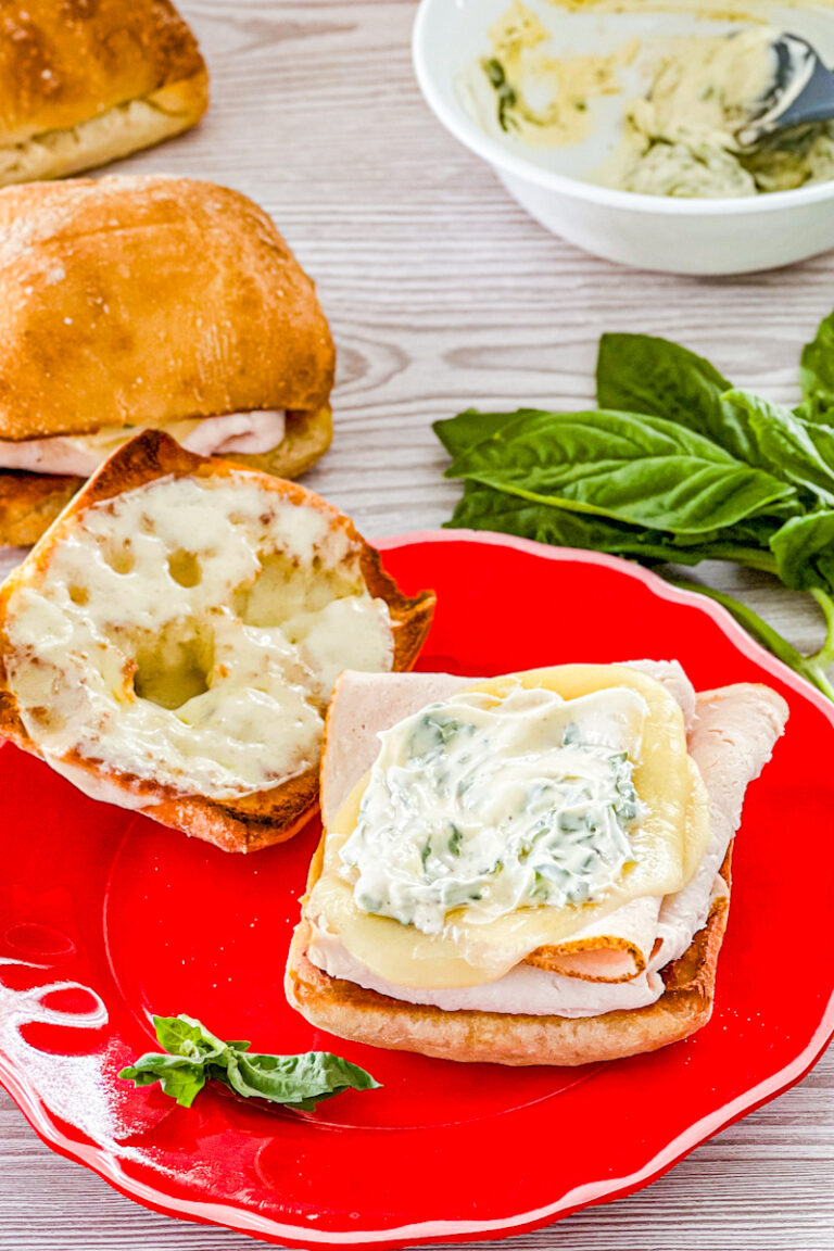 assembling turkey provolone sandwiches with basil mayo