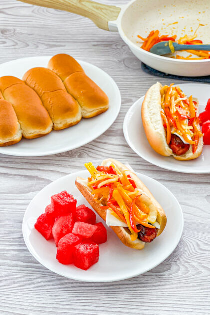 hot dog topped like philly cheesesteak sandwich
