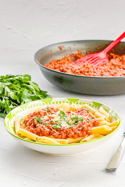 cooked pene pasta covered with rosa meat sauce