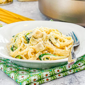 upclose bowl of creamy spinach artichoke pasta