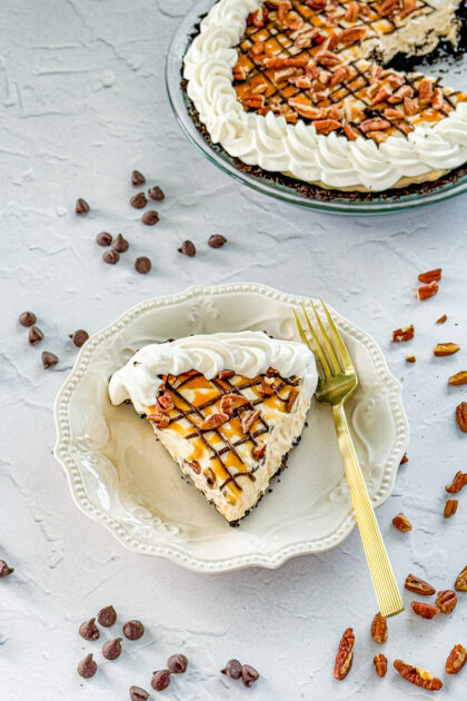 turtle pie with chocolate ganache, caramel, whipped cream, and pecans