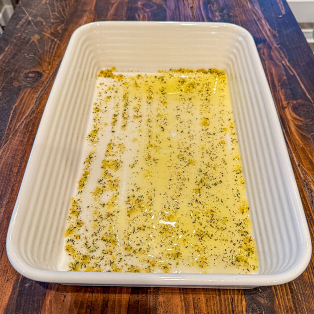 baking pan coated with olive oil mixed with seasonings