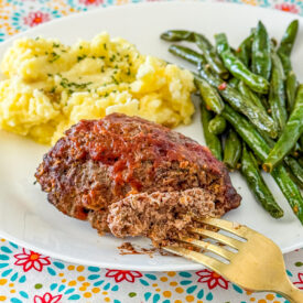 mini meatloaf with mashed potatoes and green beans all made on a sheet pan
