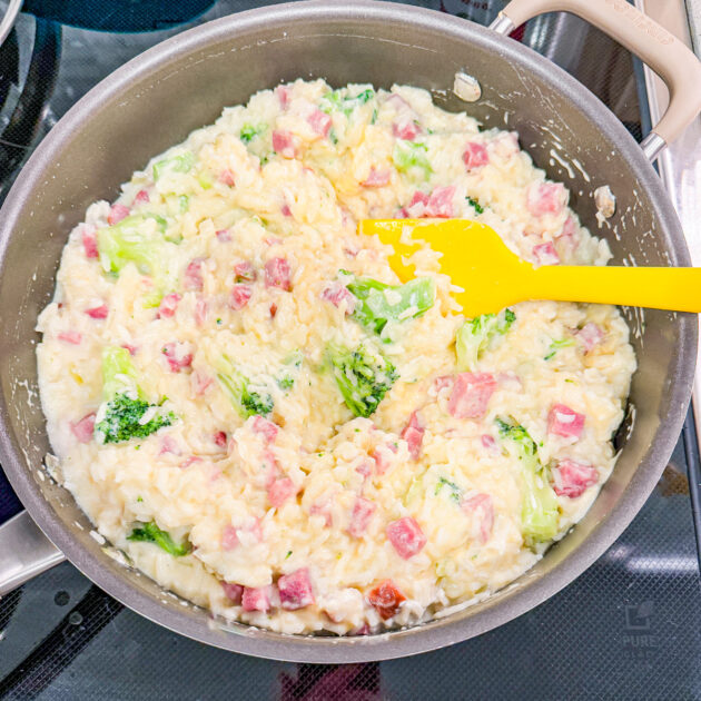 making casserole with ham, broccoli, and rice in a creamy sauce