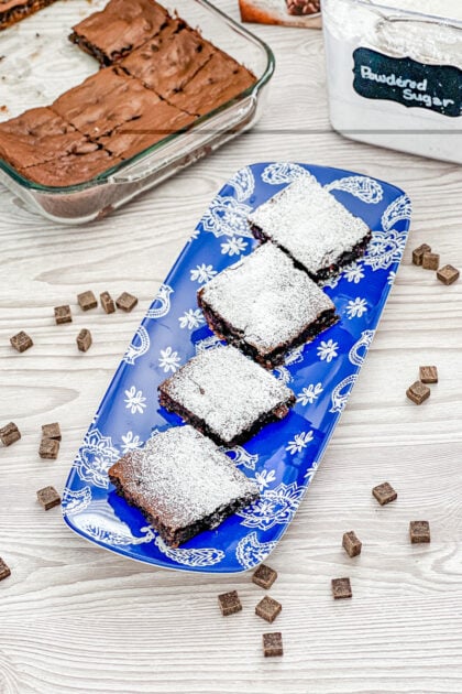 triple fudge brownies dusted with powdered sugar