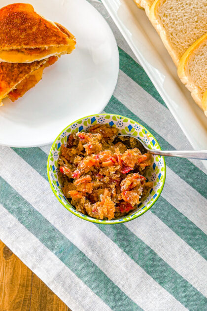 bowl of bacon jam on a green and white striped background