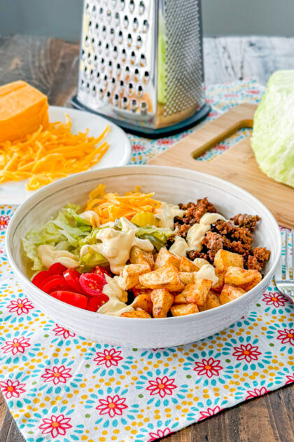 Loaded cheeseburger bowl with roasted potatoes, ground beef, cheese, lettuce, and special sauce.