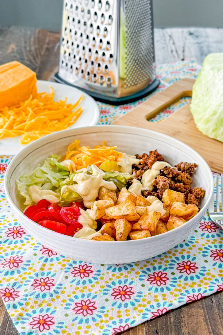 Loaded cheeseburger bowl with roasted potatoes, ground beef, cheese, lettuce, and special sauce.