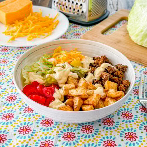 Loaded cheeseburger bowls including potatoes, ground beef, and toppings.