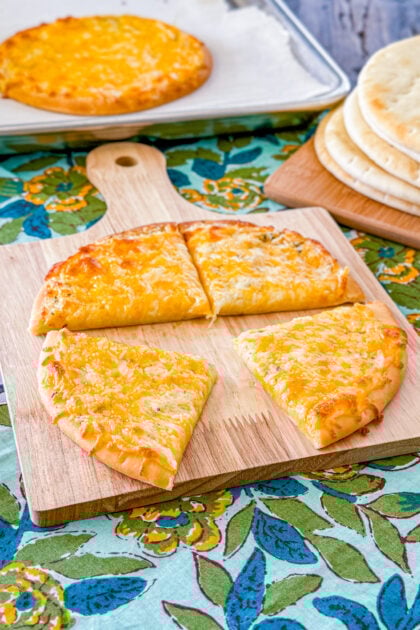 Sliced cheesy garlic pita bread with melted cheese and crispy edges.