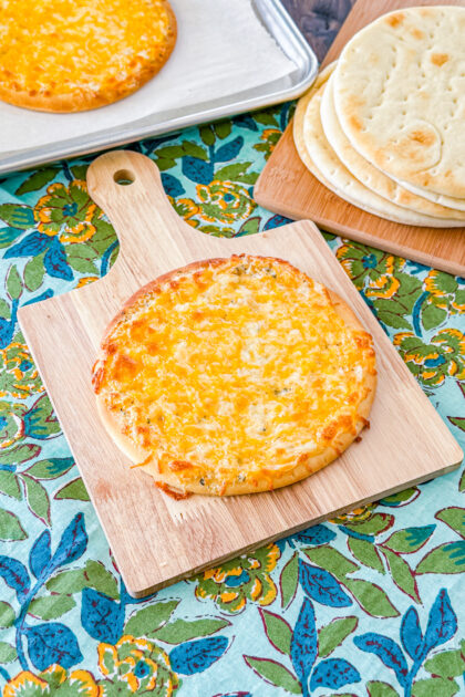 Cheesy garlic pita bread baked until golden with melted cheese on top.