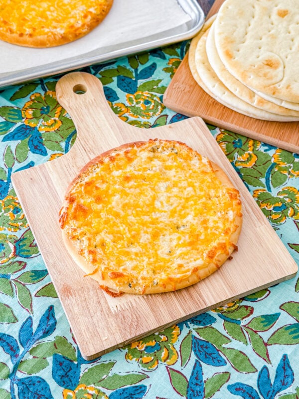 Cheesy garlic pita bread baked until golden with melted cheese on top.