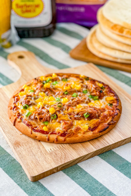 BBQ pulled pork pita pizza topped with corn, cheese, and fresh cilantro.