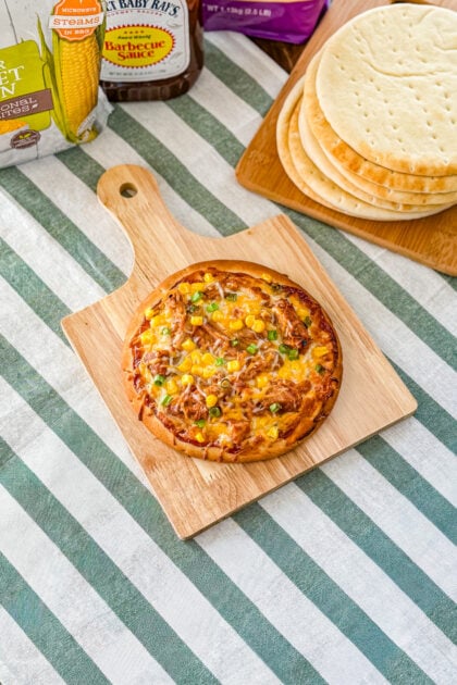 Easy BBQ pulled pork pita pizza with Sweet Baby Ray’s sauce and melted cheese.