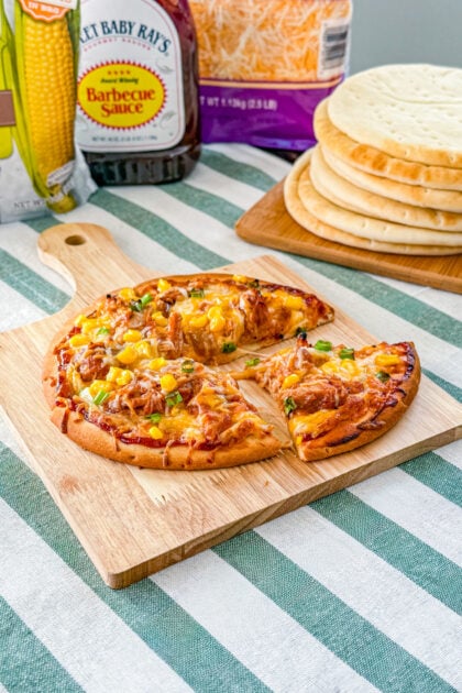 Sliced BBQ pulled pork pita pizza with corn and green onion on crispy pita crust.