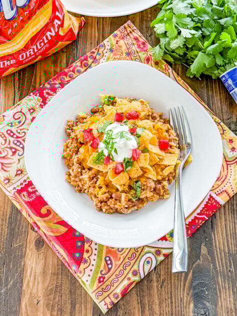 Instant Pot Frito Pie layered with seasoned beef, rice, chili beans, and crunchy corn chips.