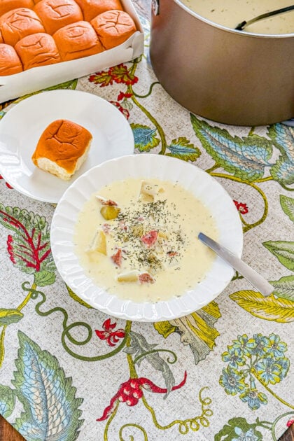 Overhead view of creamy ham and potato soup topped with fresh dill