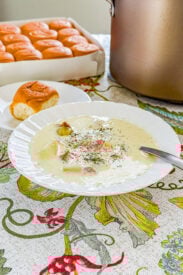 Creamy ham and potato soup with dill served in a bowl
