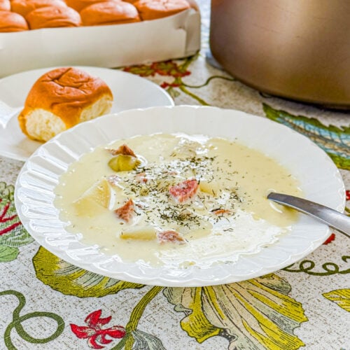 Creamy ham and potato soup with dill served in a bowl