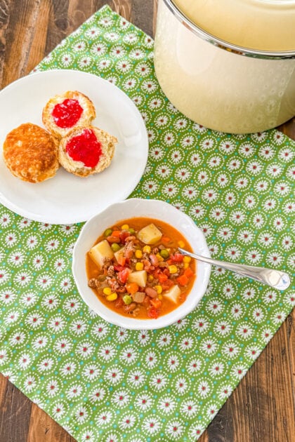 Overhead view of hearty cowboy soup in a serving bowl.