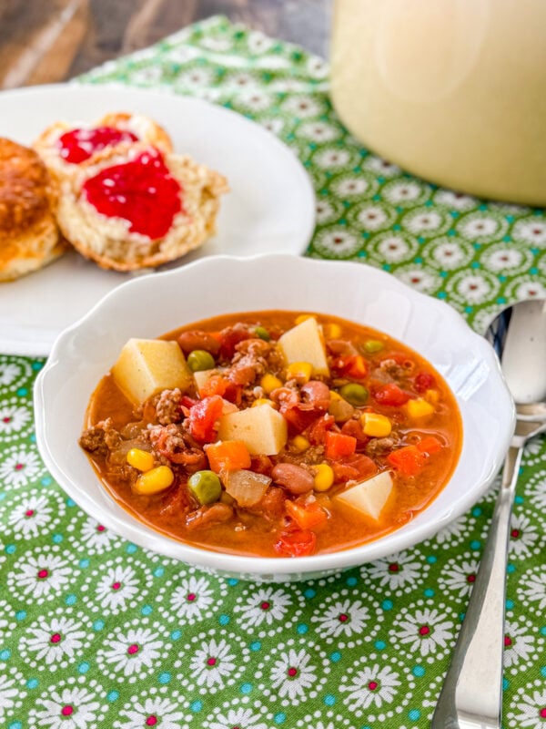 Cowboy soup with ground beef, beans, potatoes, and vegetables in a bowl.