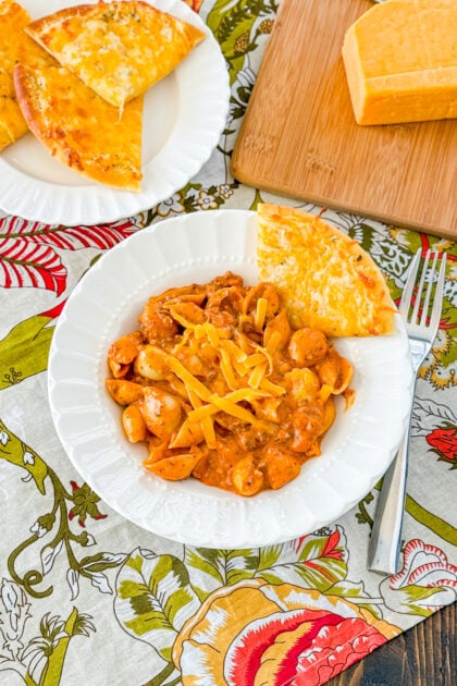 Overhead view of cheesy Italian shells pasta with tomato and cheese sauce