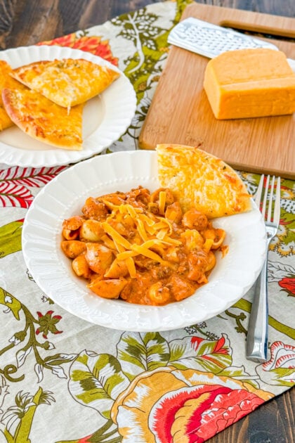 Homemade cheesy Italian shells pasta topped with cheddar cheese