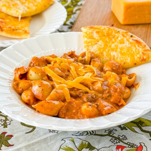 Homemade cheesy Italian shells pasta topped with Parmesan cheese