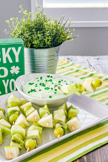 Fruit skewers dipped in creamy pistachio fruit dip