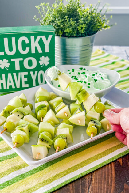 Platter of St. Patrick’s Day fruit skewers with creamy pistachio pudding dip