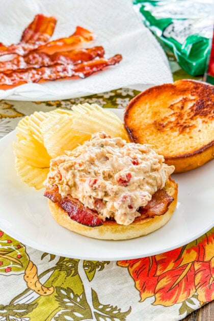 Slow cooker marry me chicken sandwich on toasted brioche bun with bacon.