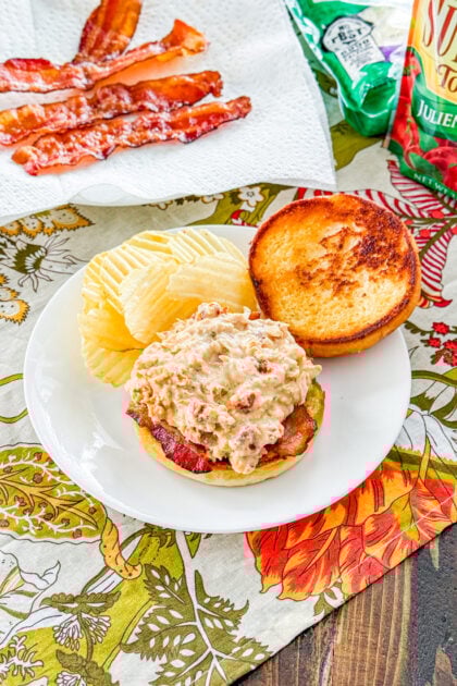 Creamy shredded marry me chicken with sun-dried tomatoes in slow cooker.