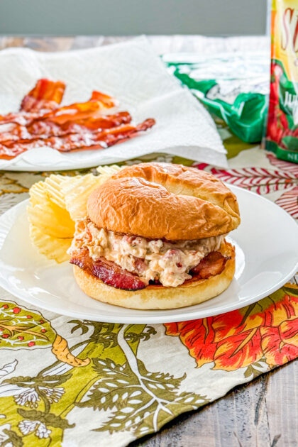 Slow cooker marry me chicken sandwich on toasted brioche bun with bacon.