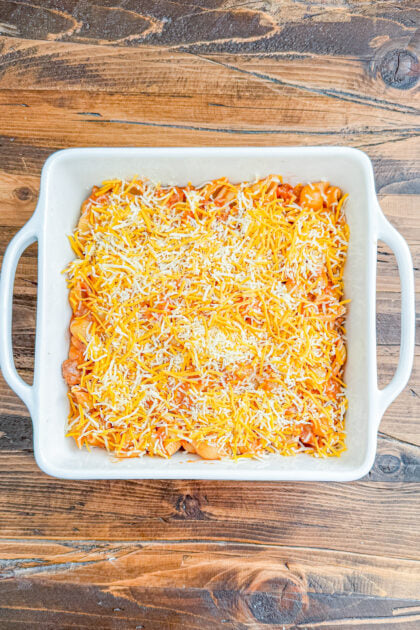 Cheeseburger pasta bake in a baking dish before baking with cheese on top