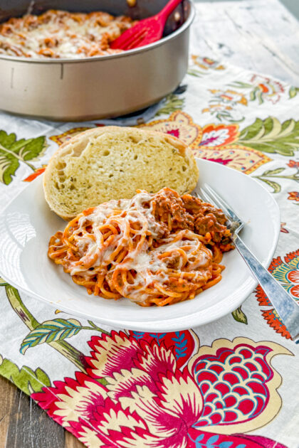 Easy Creamy Beef Skillet Spaghetti topped with melted mozzarella and Parmesan