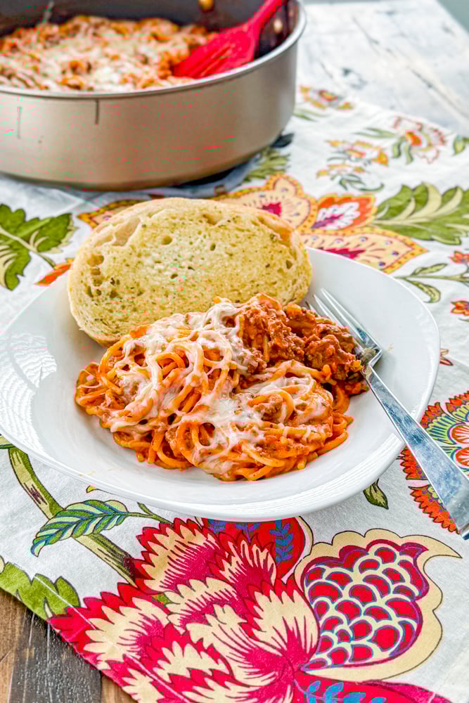 Easy Creamy Beef Skillet Spaghetti topped with melted mozzarella and Parmesan