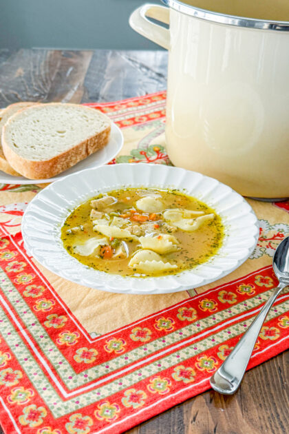 Italian chicken tortellini soup served in a bowl with chicken, vegetables, and cheese tortellini