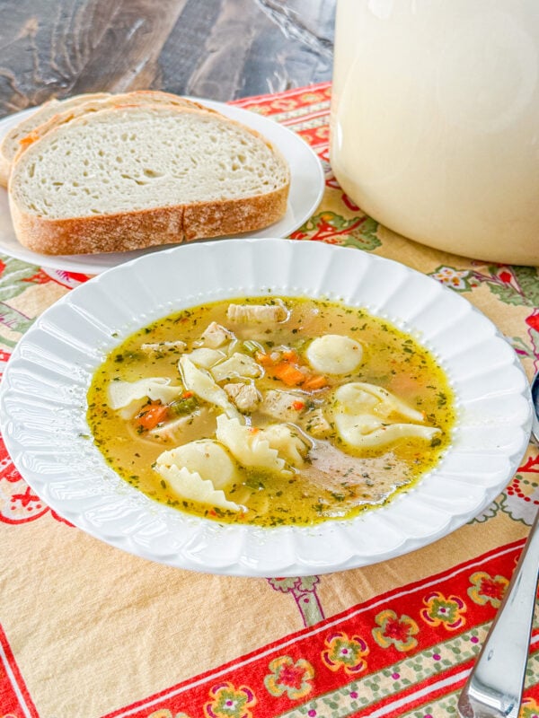 Close-up of Italian chicken tortellini soup with chicken, carrots, and cheese tortellini