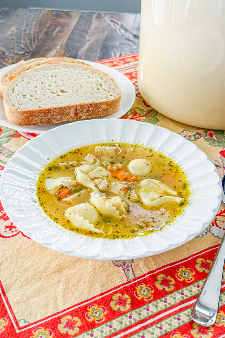 Close-up of Italian chicken tortellini soup with chicken, carrots, and cheese tortellini