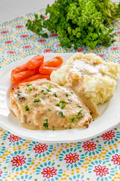 Oven baked buttermilk chicken with creamy gravy served on a plate