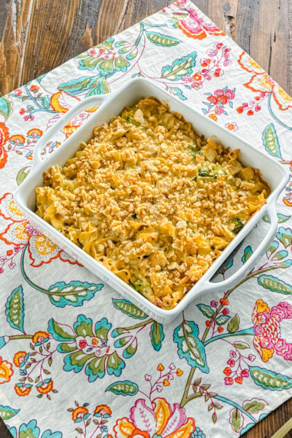 Overhead view of creamy chicken broccoli noodle casserole in a baking dish