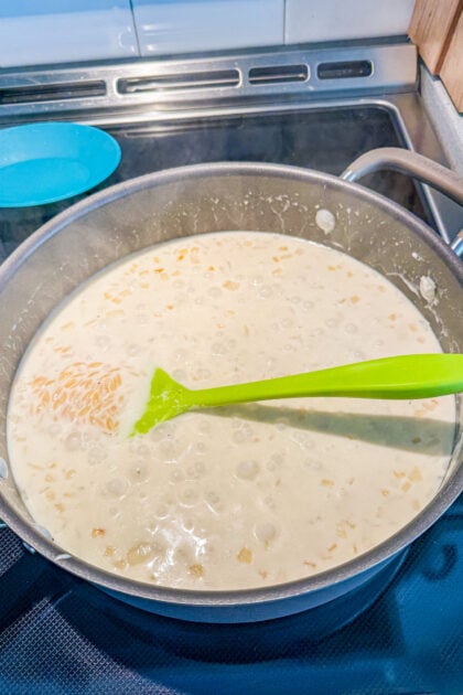 Orzo simmering in a creamy lemon sauce in a skillet