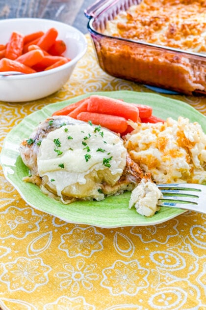 Easy baked pineapple chicken topped with pineapple rings, melted cheese, and cilantro