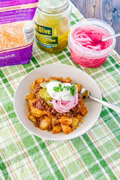 Overhead view of sloppy joe bowls with roasted potatoes and toppings