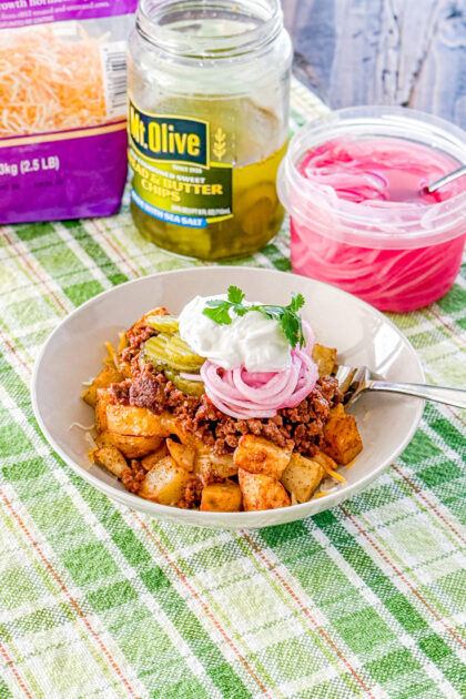 Loaded sloppy joe bowls with roasted potatoes, pickled red onions, pickles, cheese, and sour cream