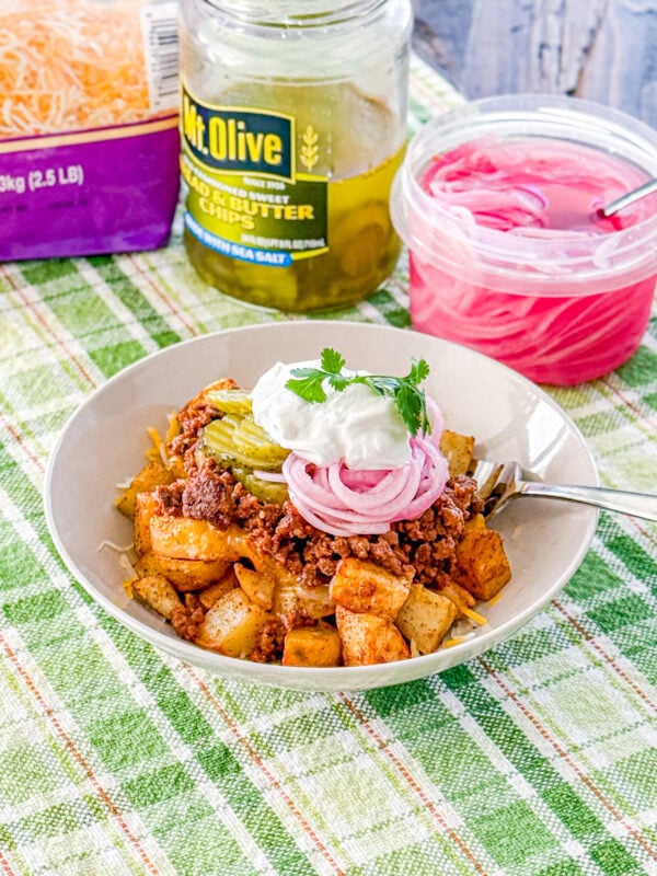 Loaded sloppy joe bowls with roasted potatoes, pickled red onions, pickles, cheese, and sour cream