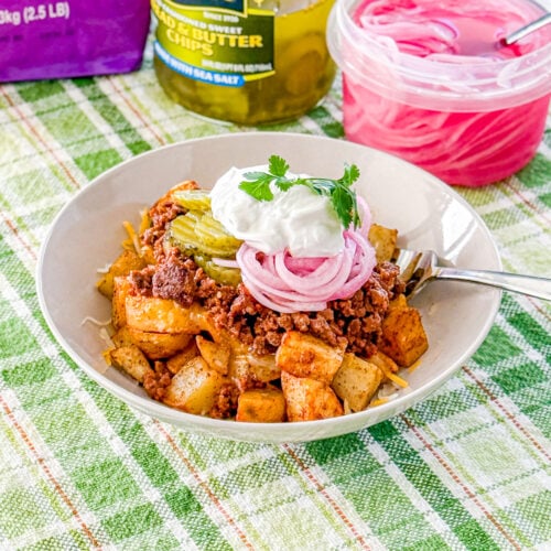 Serving of loaded sloppy joe bowls with roasted potatoes in a bowl