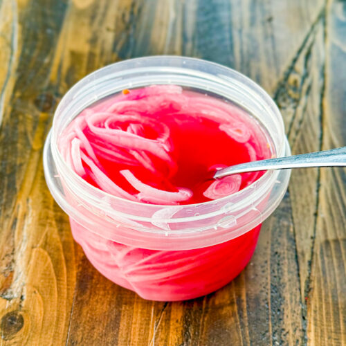 Close-up of bright pink quick pickled red onions