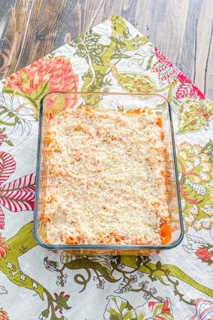 Baked five cheese ziti al forno in a baking dish with browned topping
