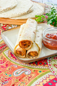 Slow cooker baked chicken taquitos served with dipping salsa